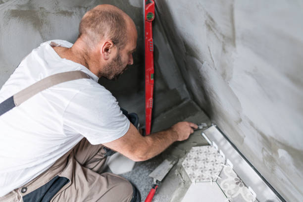 istock Male tiler working in new apartment 1205260113