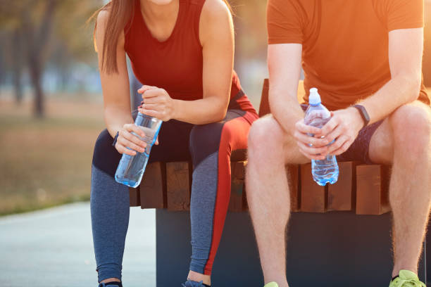 istock Modern couple making pause in an urban park during jogging / exercise. 1205260184
