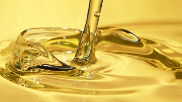 Freeze motion of pouring oil Freeze motion of pouring oil, super macro shot. pouring stock pictures, royalty-free photos & images