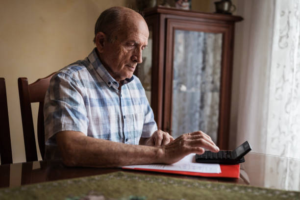 istock Senior man calculating his disability pension 1205262520