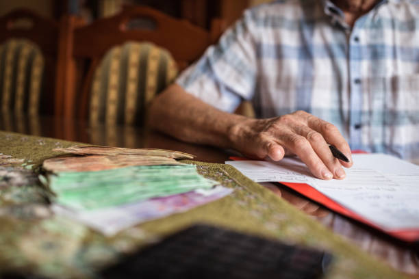 istock Man signing papers for disability pension 1205263641