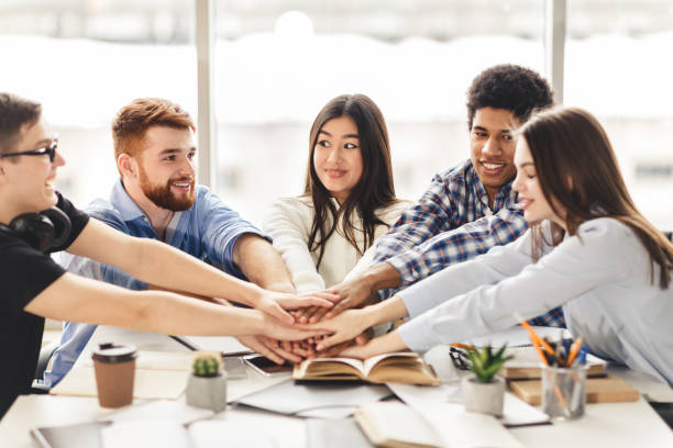 istock Teamwork concept. International students putting their hands together 1205264561