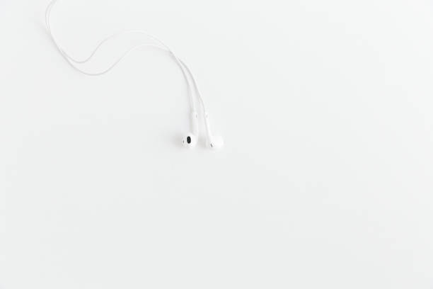 istock White earphones on the white background.Space for text,mockup.Minimalism. 1205264630