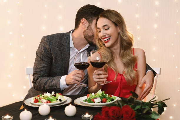 istock Romantic Man Whispering Love Words To Girlfriend On Date In Restaurant 1205268957