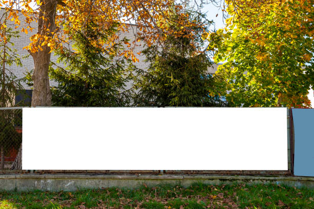 istock Blank white banner for advertisement on the fence. 1205269941