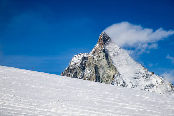 istock skiing under Matterhorn peak against blue sky Swiss Alps 1205271342