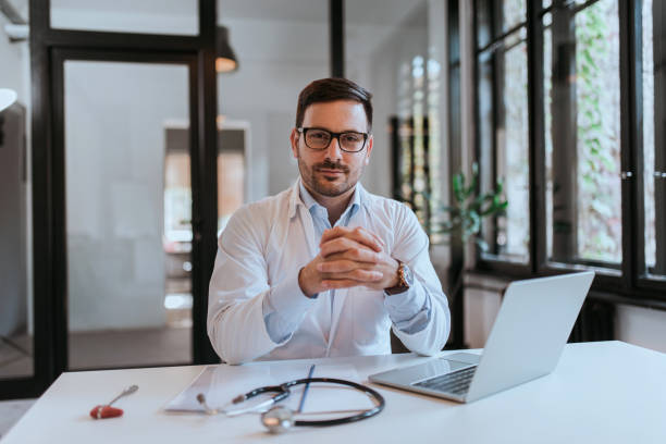 istock Portrait of a successful handsome doctor at workplace. 1205271943