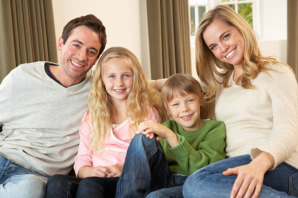istock Happy young family sitting on sofa 120527334