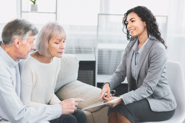 Mature couple consulting with adviser at office