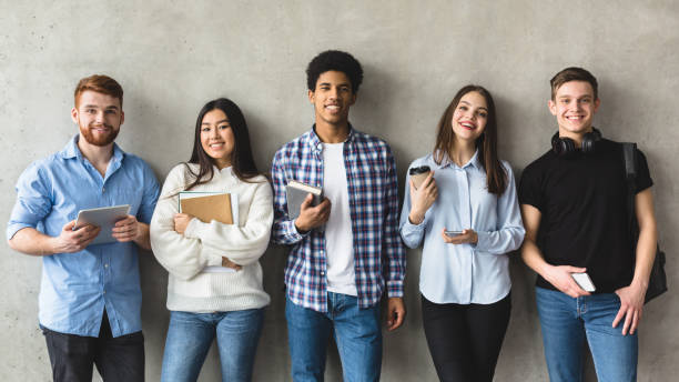 istock Multiethnic group of university students against college wall 1205274217