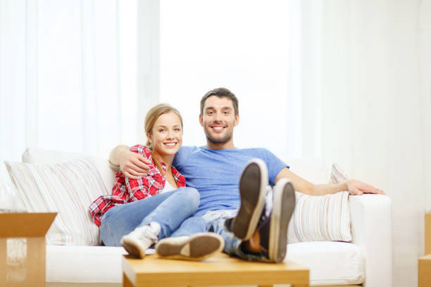 istock smiling couple relaxing on sofa in new home 1205274594