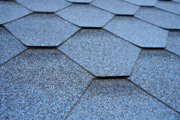 istock Close up view on asphalt roofing shingles. 1205274782