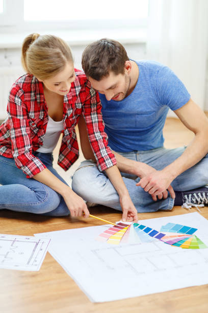 istock smiling couple looking at color samples at home 1205274879