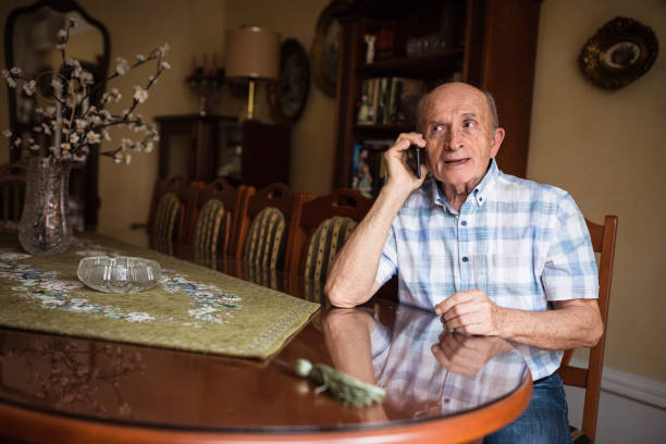 istock Serious senior man talking on phone 1205274976