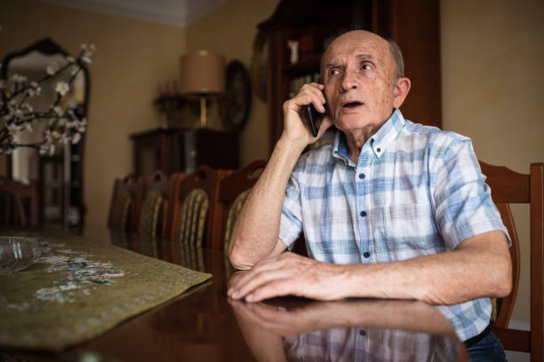 istock Worried old man talking on phone 1205275021