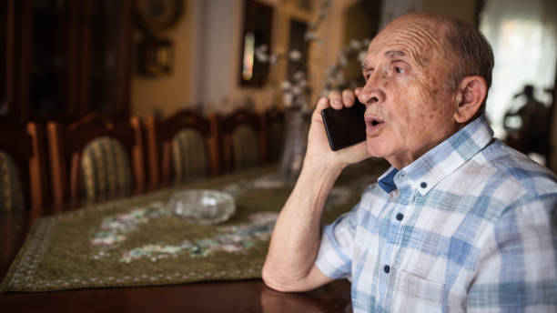 istock Serious grandfather talking on phone 1205275063