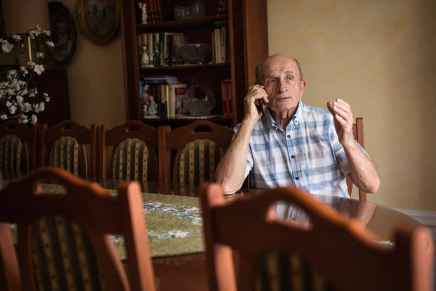 istock Depressed old man talking on phone 1205275115