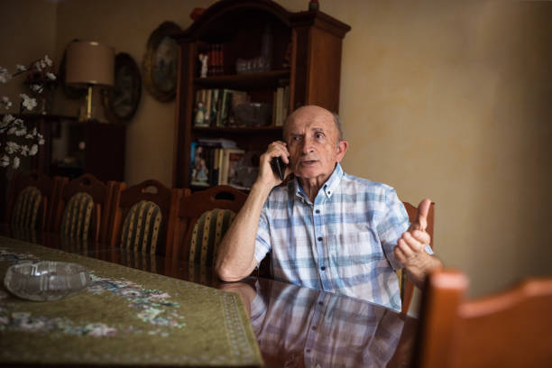 istock Serious senior man talking on phone 1205275158