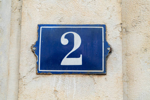 istock House number 2 Blue on white on a old French wall 1205275287