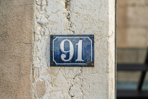 House number 91 Blue on white on a old French wall