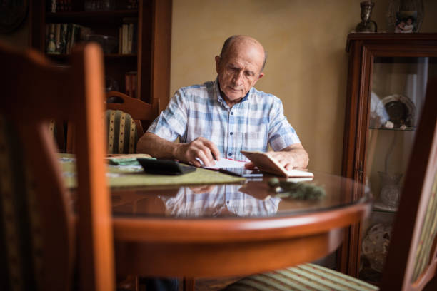 istock Older man calculating his monthly bills 1205275810