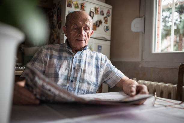 istock Old man with the Morning Newspaper 1205276962