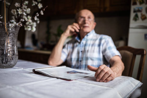 istock Serious man with eyeglasses talking on phone 1205276970