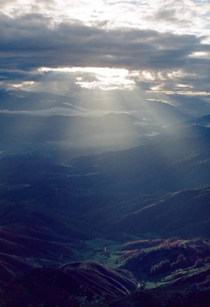 istock Sun rays break through the clouds sky over a Nepalese landscape 1205277720