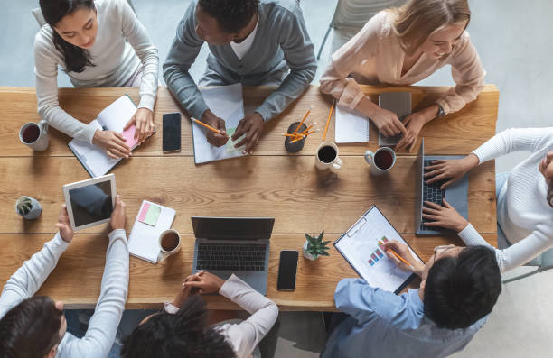 istock Multiracial business team having meeting, top view 1205277943