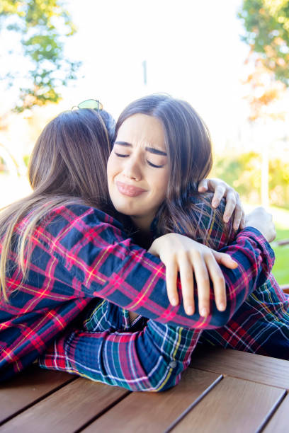 istock Two sad best female friends embracing each other 1205278007