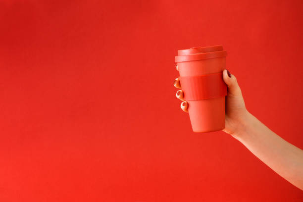 Female hand holding coffee cup stock photo