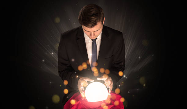 istock Businessman  sitting with sparkling magic ball 1205280005