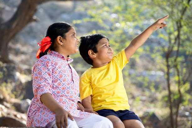 Brother and sister spending leisure time at park
