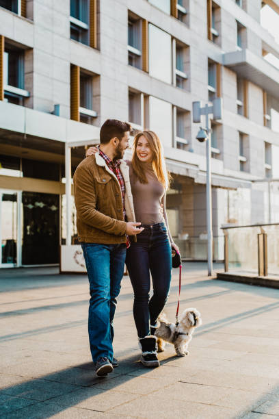 istock Young couple walking their dog 1205281565
