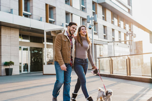 istock Young couple walking their dog 1205281589