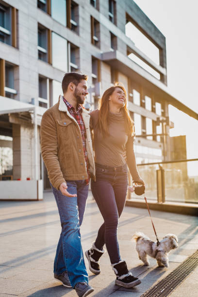 istock Young couple walking their dog 1205281835