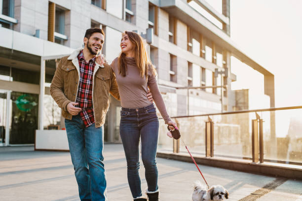 istock Young couple walking their dog 1205282020