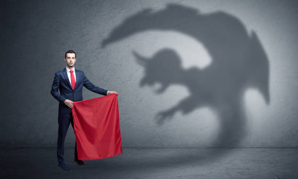 istock Businessman with imp shadow and toreador concept 1205283038