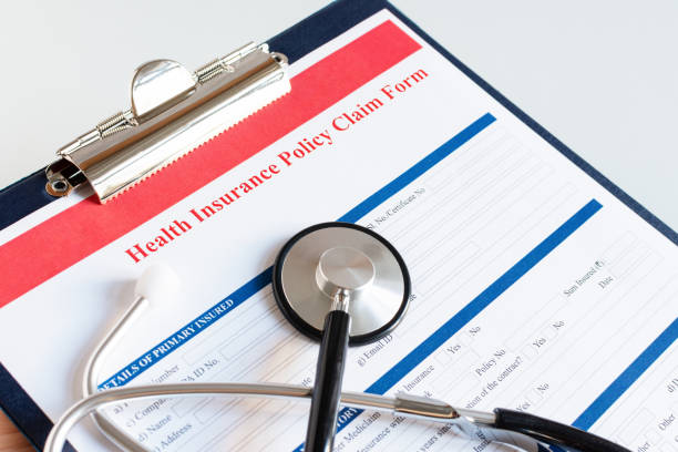 istock Blank health insurance policy claim form with stethoscope on clipboard. 1205283099