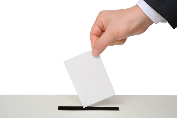istock Man's hand down the ballot in the ballot box. 1205285465