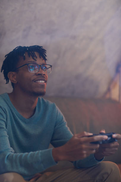 istock Smiling African-American Man Playing Videogames 1205285504