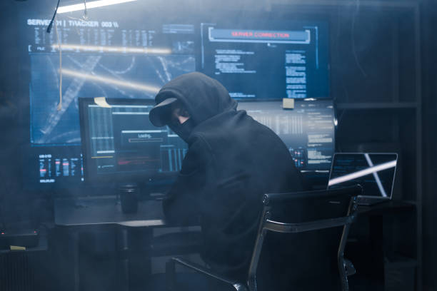 istock Hacker anxiously turns around because he knows that everyone in the country are looking for him. Computer terrorist's sistem has been compromised, and FBI and CIA are looking for him. 1205286110