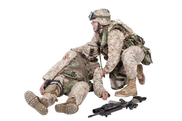 istock Soldier leaned down over wounded brother in arms 1205286140