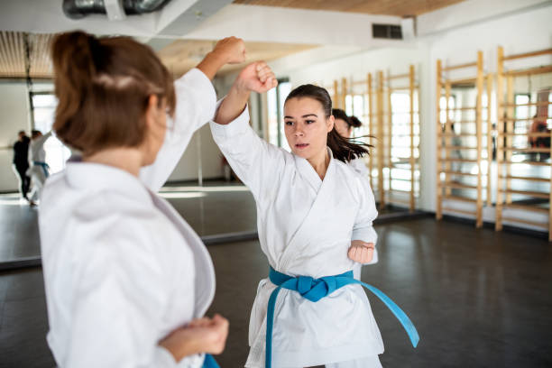 istock Young women practising karate indoors in gym. 1205287036