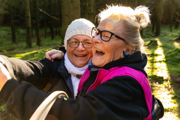 istock Two senior ladies taking selfies in the forest 1205287368