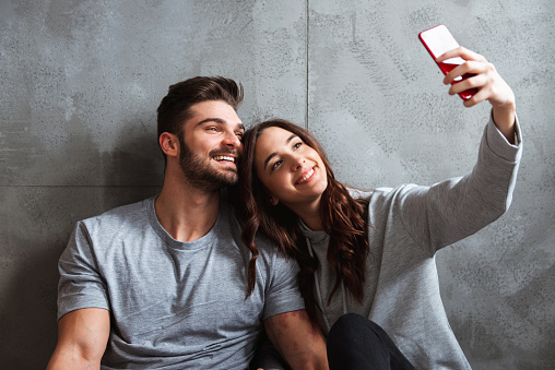 Couple is taking a selfie in their new apartment.