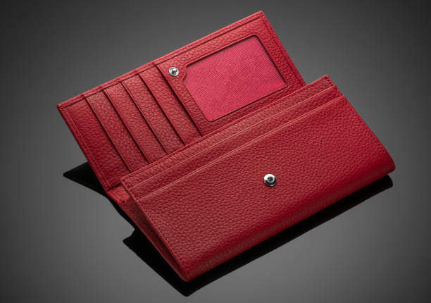 istock women's wallet on a black background 1205288118