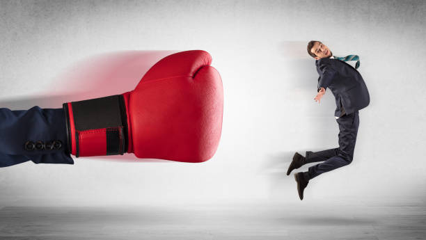 istock Big hand boxing little businessman 1205288850