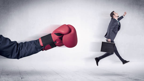 istock Huge Boxing Gloves punches businessman concept 1205288918