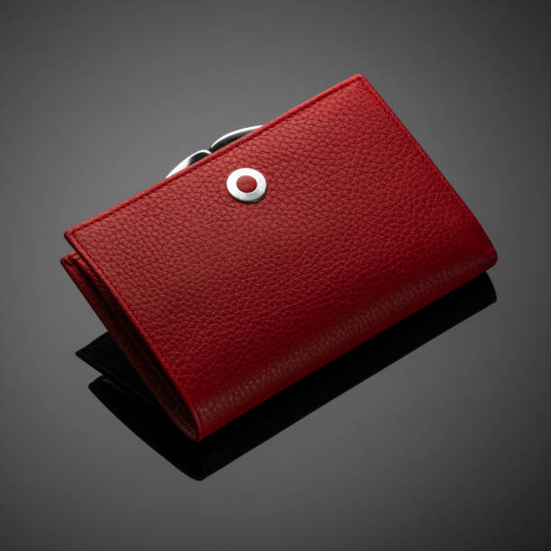 istock women's wallet on a black background 1205289173